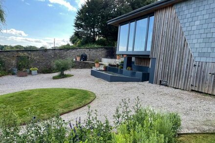 Contemporary cottage nestled in valley with beautiful views.