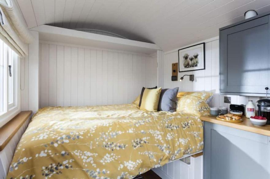 This pretty shepherds hut has been designed carefully with a king-size bed