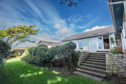 Seaside House, huge living room opens onto elevated lawn. 2-minute walk to beach