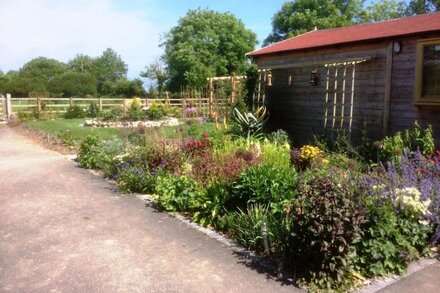 Holiday cottage in rural setting within quiet coastal village.