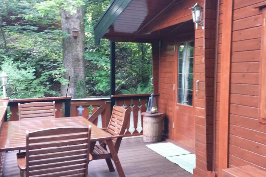 Luxury pine log cabin positioned within the mountains of the Lake District