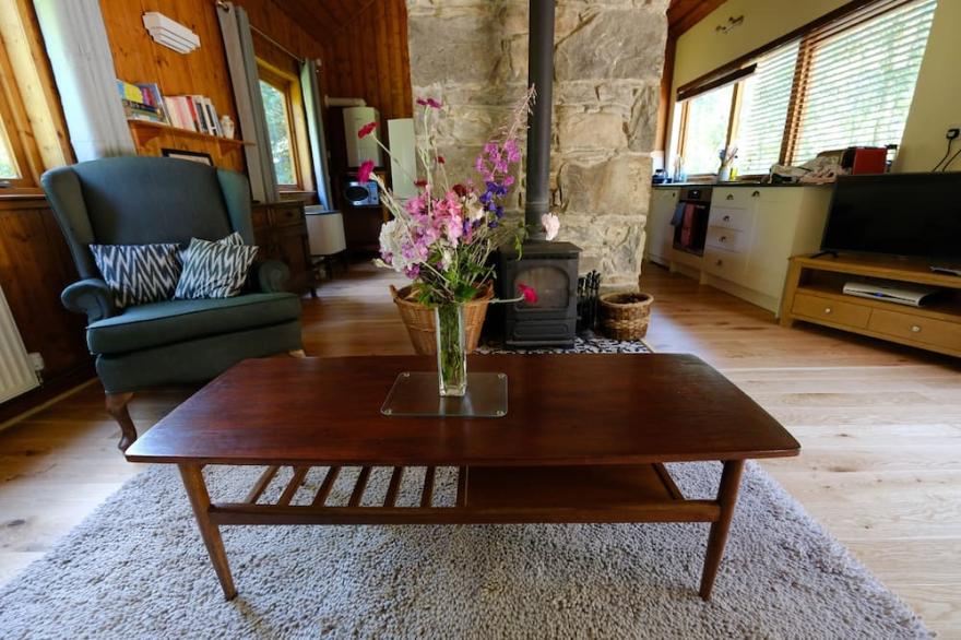 Secluded woodland cottage on the banks of a pristine Highland river