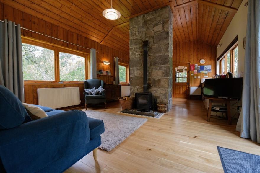 Secluded woodland cottage on the banks of a pristine Highland river