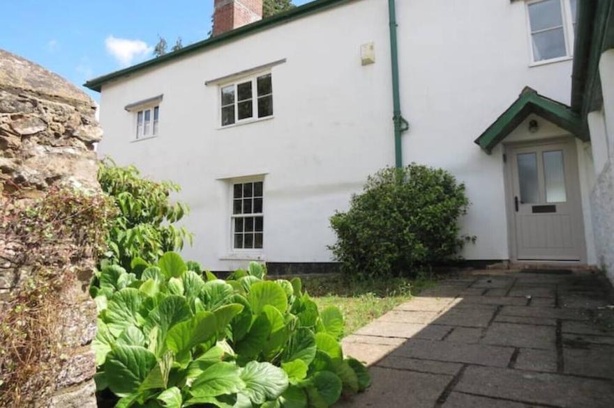 East wing of rustic farmhouse near Devon border