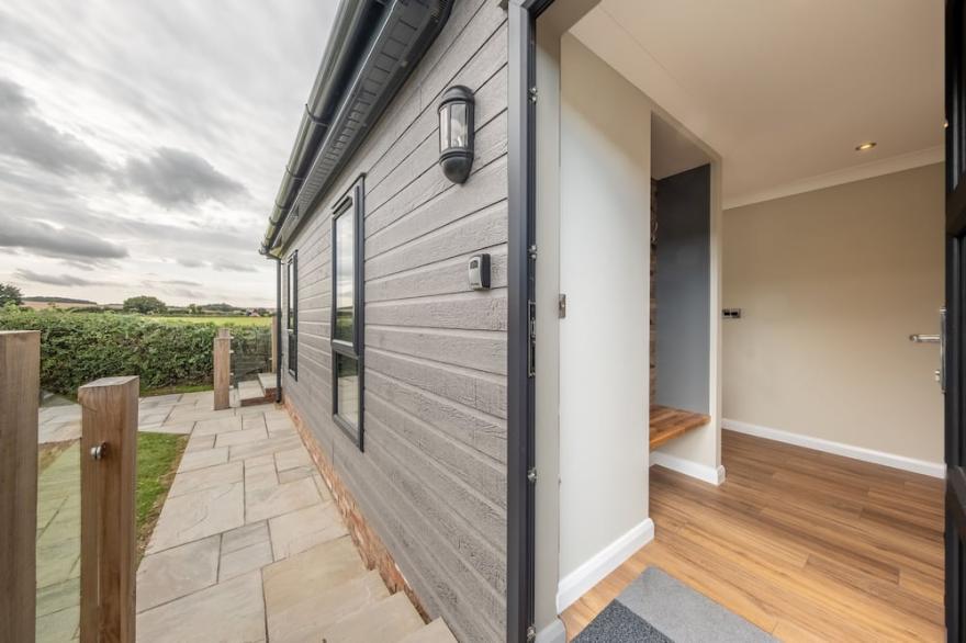 A fabulous, supremely comfortable, brand spanking new lodge, with open countryside views. Located a