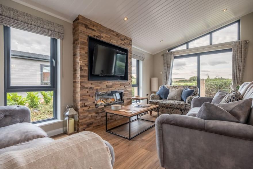 A fabulous, supremely comfortable, brand spanking new lodge, with open countryside views. Located a