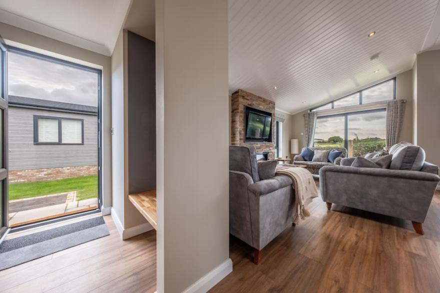 A fabulous, supremely comfortable, brand spanking new lodge, with open countryside views. Located a