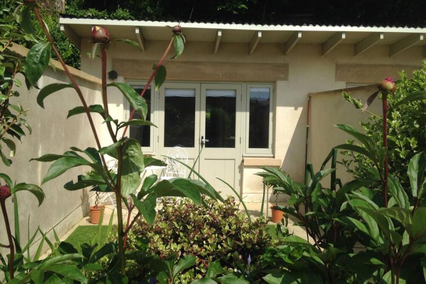 The Potting Shed is a small cabin with an ensuite showeroom, pe