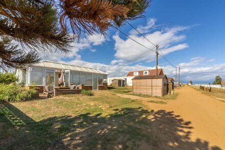 Walk right out the door of this property to feel the sand between your toes.