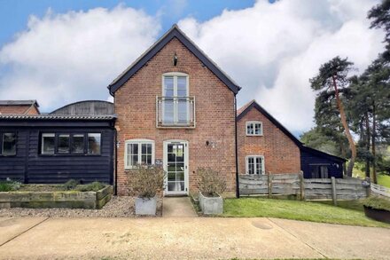 This stunning retreat has spectacular views across rolling pasture.