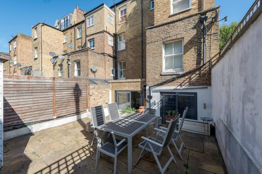 Attractive apartment with private patio in fashionable Fulham by UnderTheDoormat