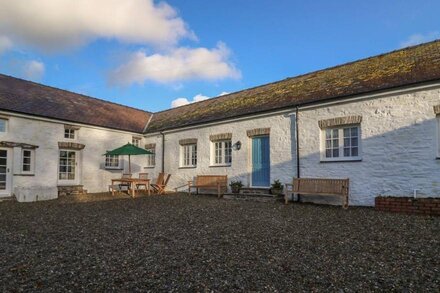 THE OLD CARRIAGE COURT, pet friendly, with open fire in Kidwelly