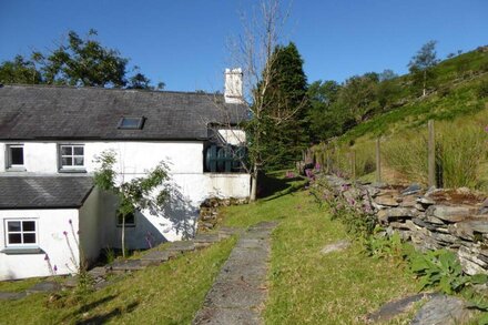 Traditional 18th century farmhouse on the slopes of a mountain