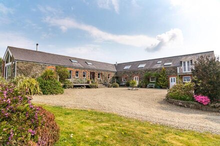 Spacious converted rural barn. Sea views, large grounds, family & pet friendly.