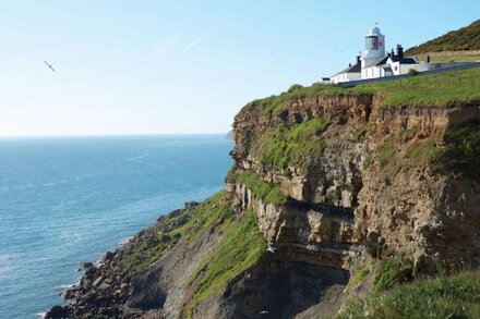 This attractive cottage on the Whitby Lighthouse site has a raised deck giving wonderful views.