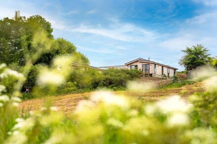 A fabulous contemporary cedar lodge with panoramic countryside and coastal views