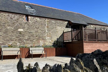 The Old Wagon House, a converted 19th century stone barn featuring lovely views over the fields and sea