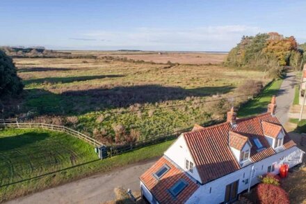 This delightful white-washed traditional, detached character cottage is in a stunning location.