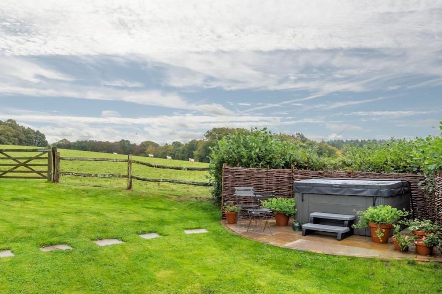 A light and airy property with a hammock and hot tub, situated on a working farm