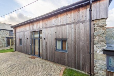 A converted barn that has been restored into a bright, modern holiday home.