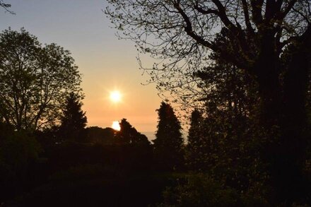 Seaview from bedroom, lounge and bathroom within an acre garden of tennis court