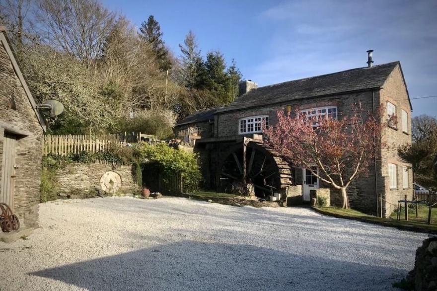 Tranquil mill in secluded valley near the sea