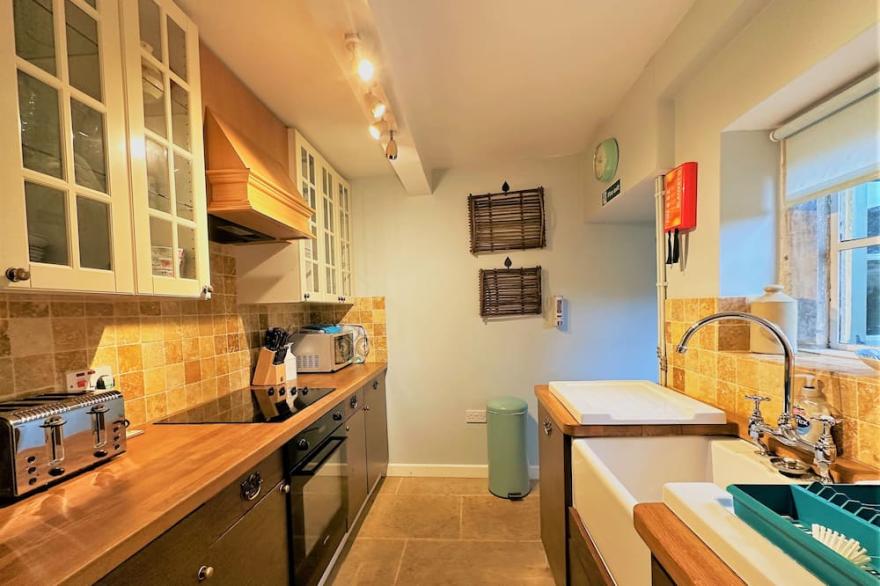 A Quaint Grade 11 Listed Detached Stone Cottage In Lower Slaughter with parking.
