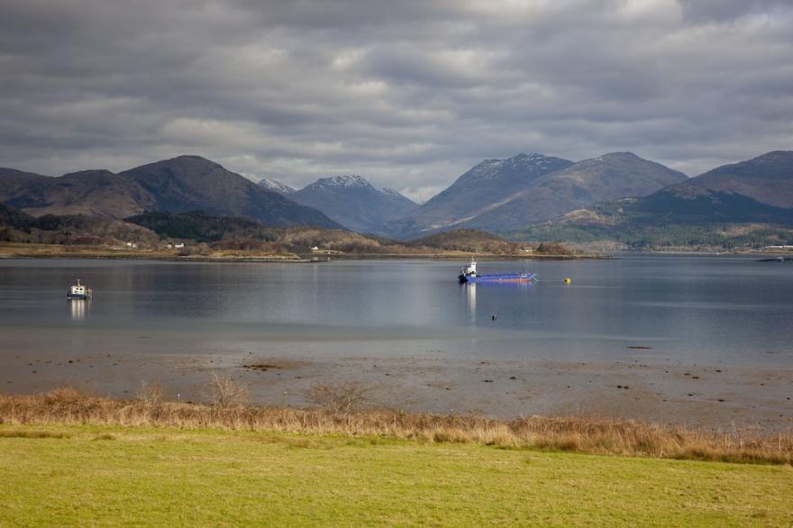 Luxury waterfront property with outdoor hot tub on shore of Scottish sea Loch.