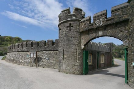 Turreted gatehouse to the historic Caerhays Castle located on the beach on the south Cornish Coast