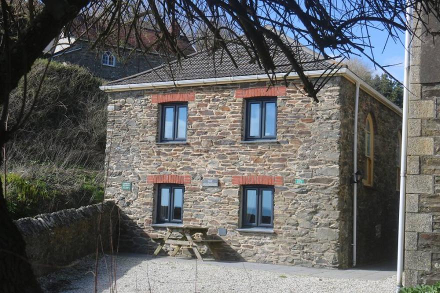 Wonderful reverse level conversion located on the sea front in picturesque rural hamlet on the South