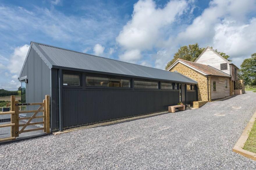 A stylish former milking parlour with outstanding rural views of Dorset.