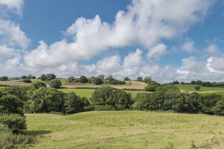 A stylish former milking parlour with outstanding rural views of Dorset.